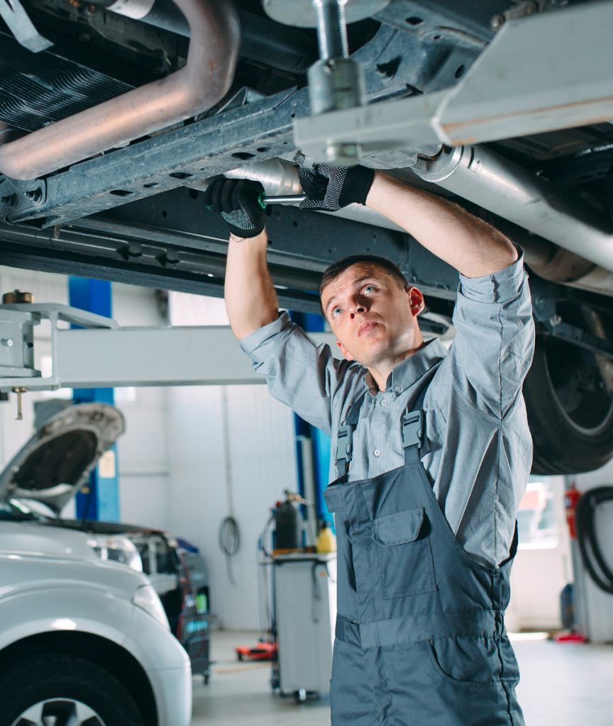 Auto mechanic inspecting underneath a vehicle - MOT Testing, Servicing, Repairs, Tyres & More in Soham